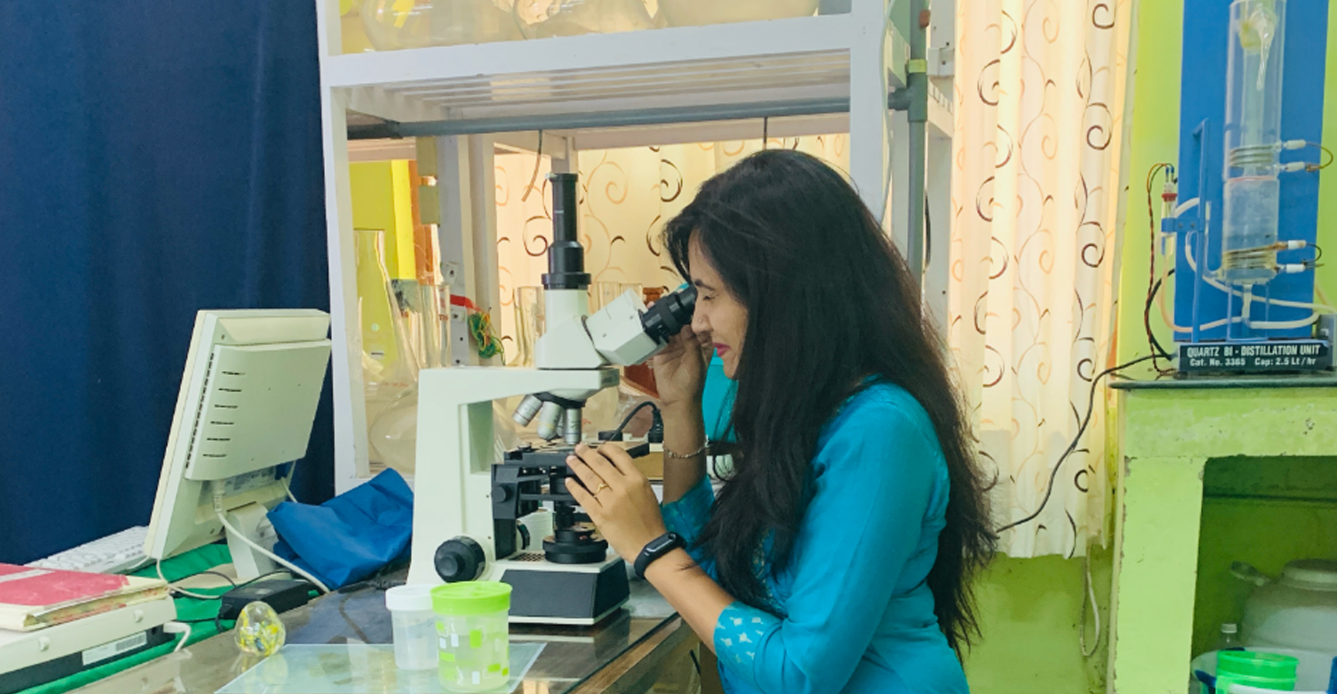 Researcher examining marine samples under microscope